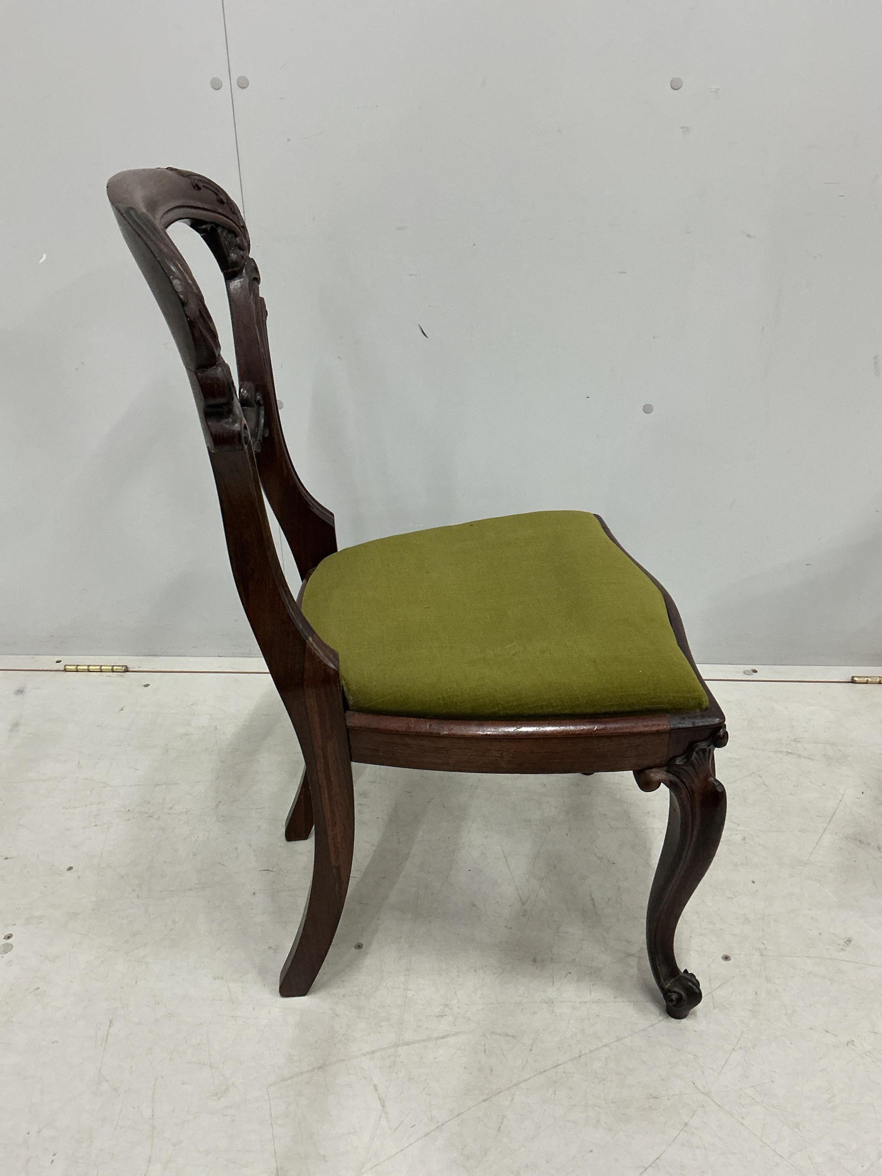 A set of four early Victorian rosewood balloon back dining chairs, height 86cm